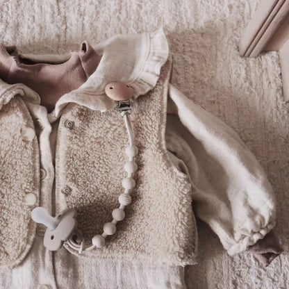 Comforting silicone teether securely fastened to a baby pacifier clip for easy access.