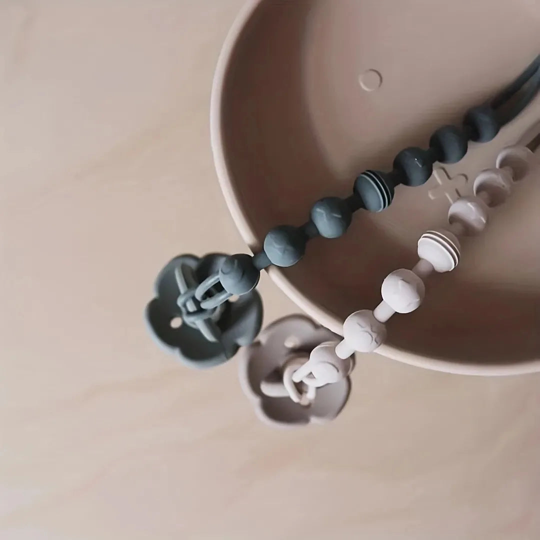 Close-up of a baby silicone pacifier clip and teether, a perfect feeding accessory for infants.