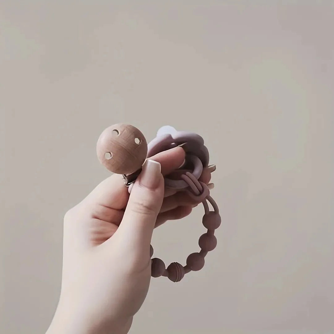 Baby safety: durable silicone pacifier clip with chewable teether, preventing pacifier drops.