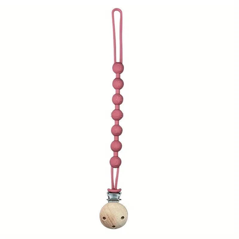 Nursing essential: grey silicone pacifier clip with an elephant-shaped teether for little ones.