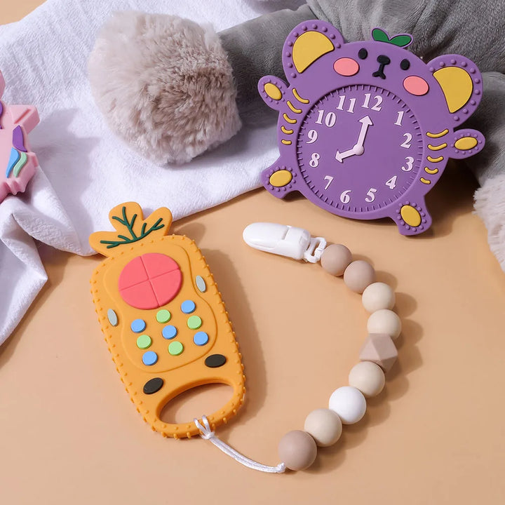 Set of colorful baby silicone remote control teethers: pink, blue, gray trio