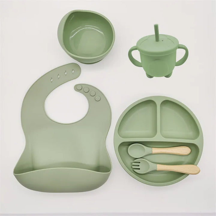 Premium silicone baby self-feeding kit: divided plate, suction bowl, waterproof bib, & toddler spoon.