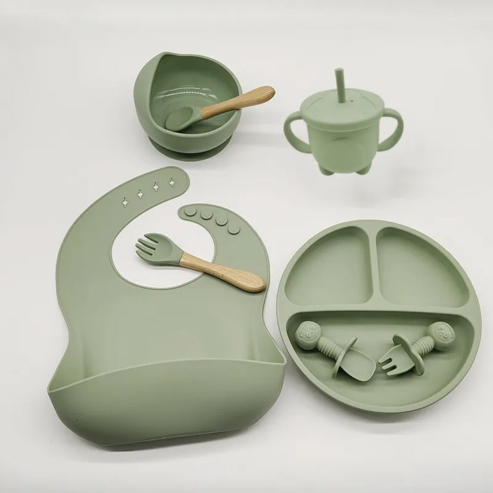 Eco-friendly silicone baby self-feeding essentials. Non-toxic, BPA-free plate, bowl, bib, & utensils.