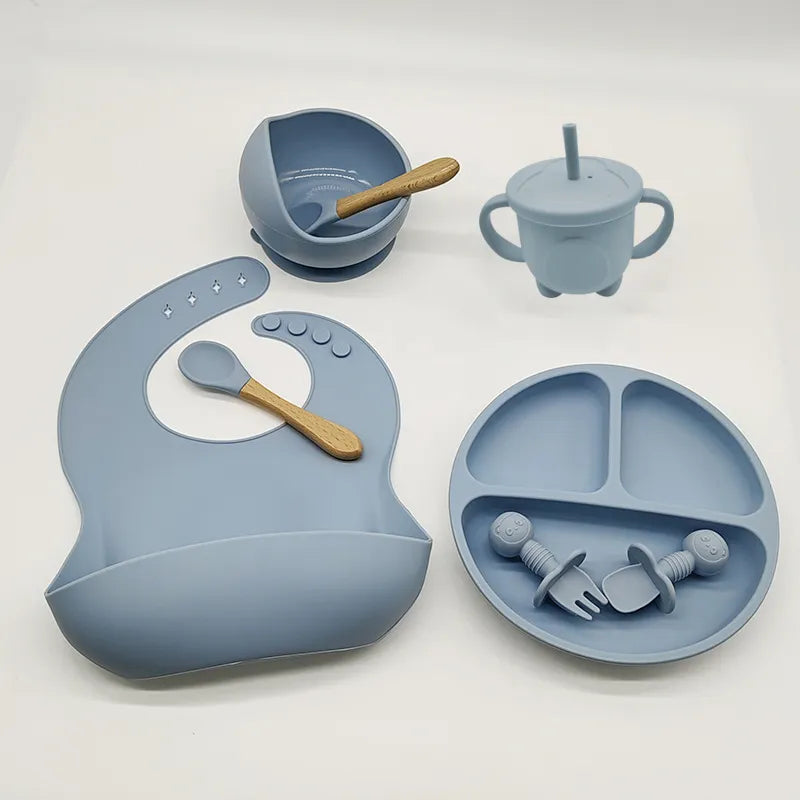 Durable baby silicone dinner set, perfect for little hands. Self-feeding plate, bowl, bib, & utensils.