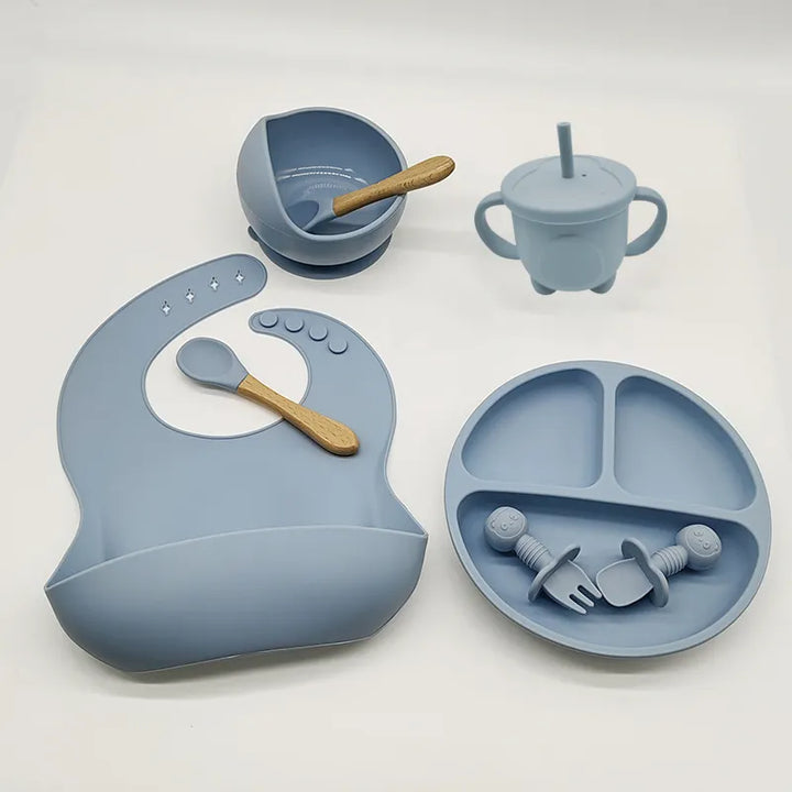 Durable baby silicone dinner set, perfect for little hands. Self-feeding plate, bowl, bib, & utensils.