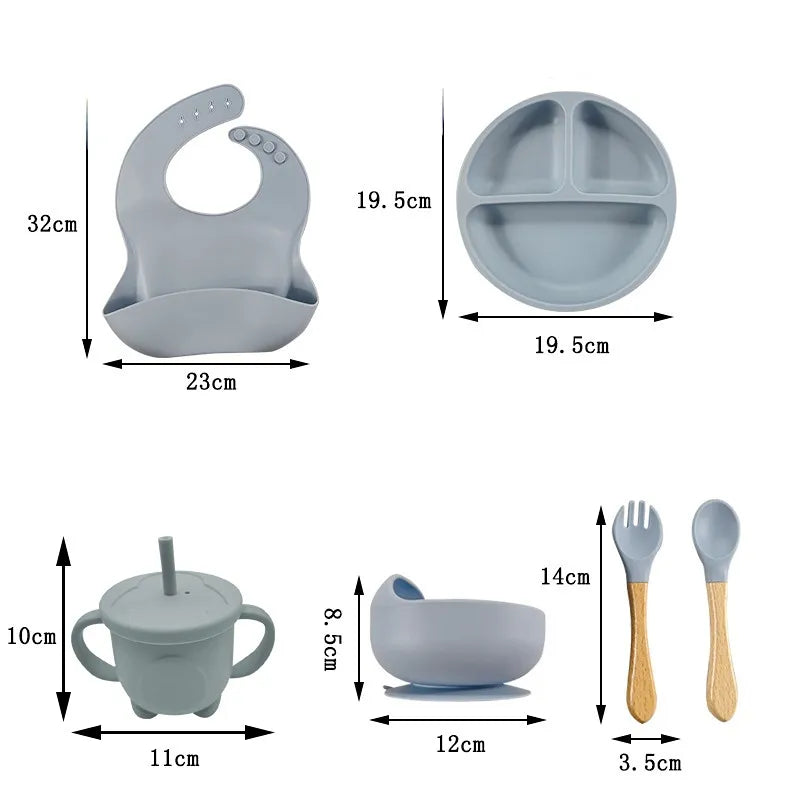 Non-toxic silicone baby feeding set. Suction bowl, divided plate, waterproof bib, and soft spoons.