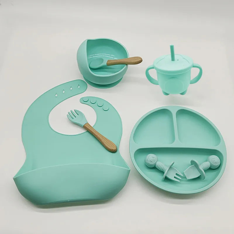 Soft silicone baby bib & matching self-feeding plate for mess-free toddler mealtime.