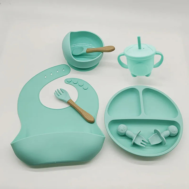 Soft silicone baby bib & matching self-feeding plate for mess-free toddler mealtime.