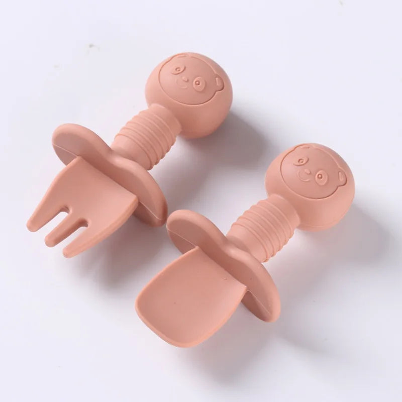 Toddler feeding set featuring a silicone spoon and fork with charming wooden handles