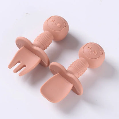 Toddler feeding set featuring a silicone spoon and fork with charming wooden handles
