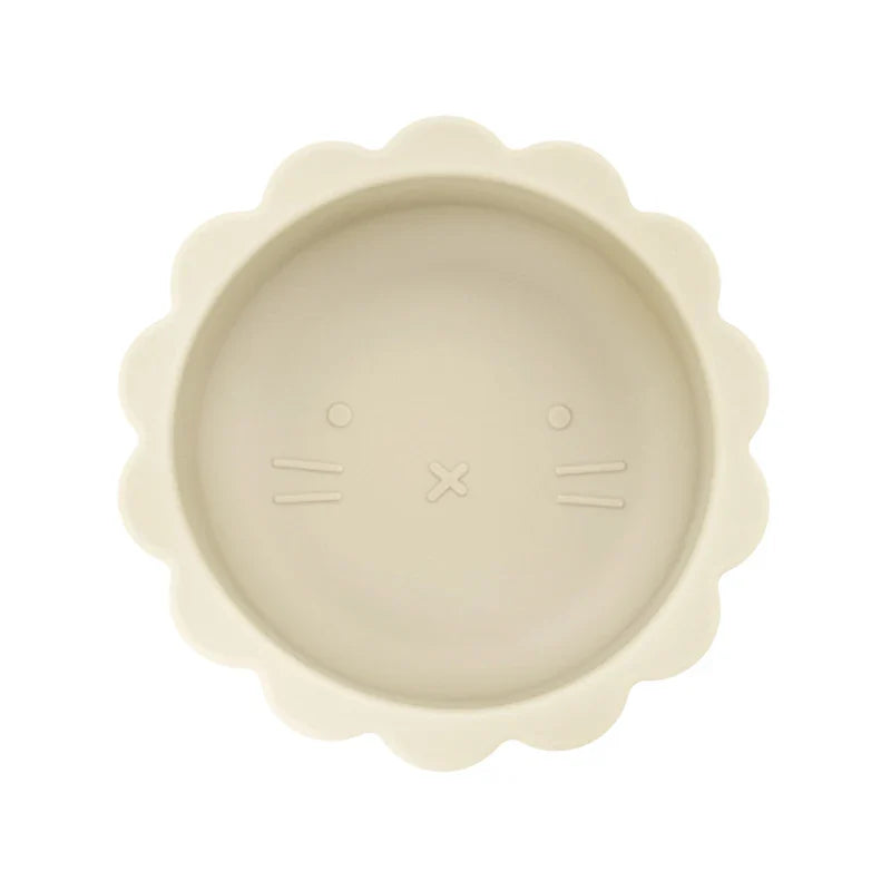 Baby silicone suction bowl with lid alongside a spoon, ready for mealtime