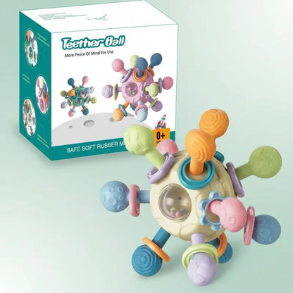 Adorable baby gripping a soft silicone teether ball, engaging in early developmental play.