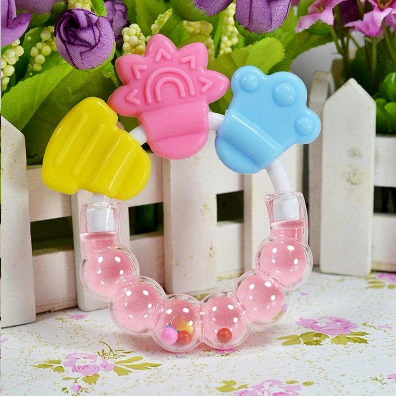 Soft silicone baby teether rattle with easy-grip handle, a safe chew toy for newborns and infants.