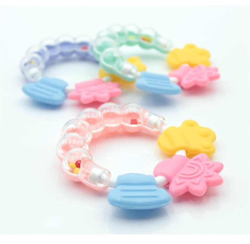 Ergonomic silicone baby teether rattle, ideal for little hands, promoting oral development in infants.