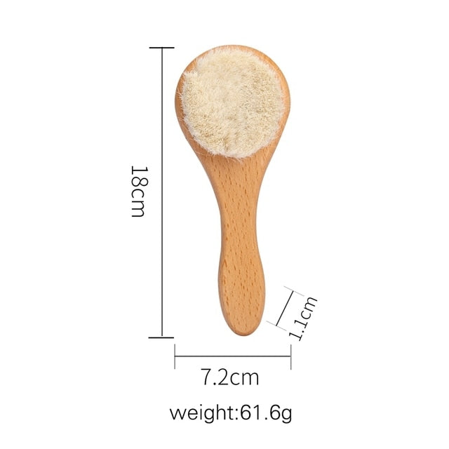 Close-up of baby wooden hair brush with soft bristles for gentle infant scalp care and massage