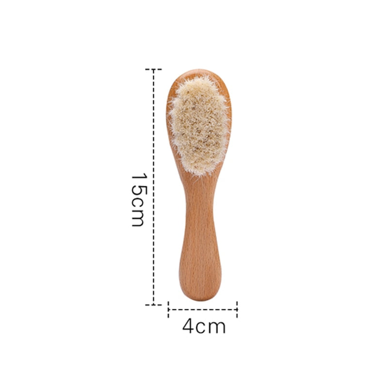 Soft bristle baby brush with smooth wooden handle, designed for gentle use on newborn scalps