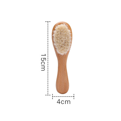 Soft bristle baby brush with smooth wooden handle, designed for gentle use on newborn scalps