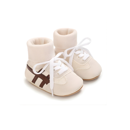 Close-up of soft sole baby footwear, cotton material, designed for infant comfort and anti-slip walking.
