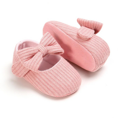 Side view of a breathable, anti-slip baby shoe with a soft sole, excellent for infant first steps.