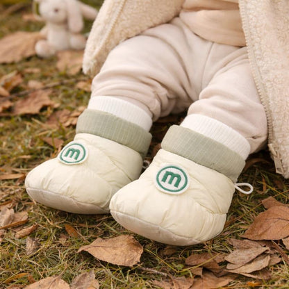 Baby soft sole fleece-lined first walking shoes for infants, promoting healthy foot development.