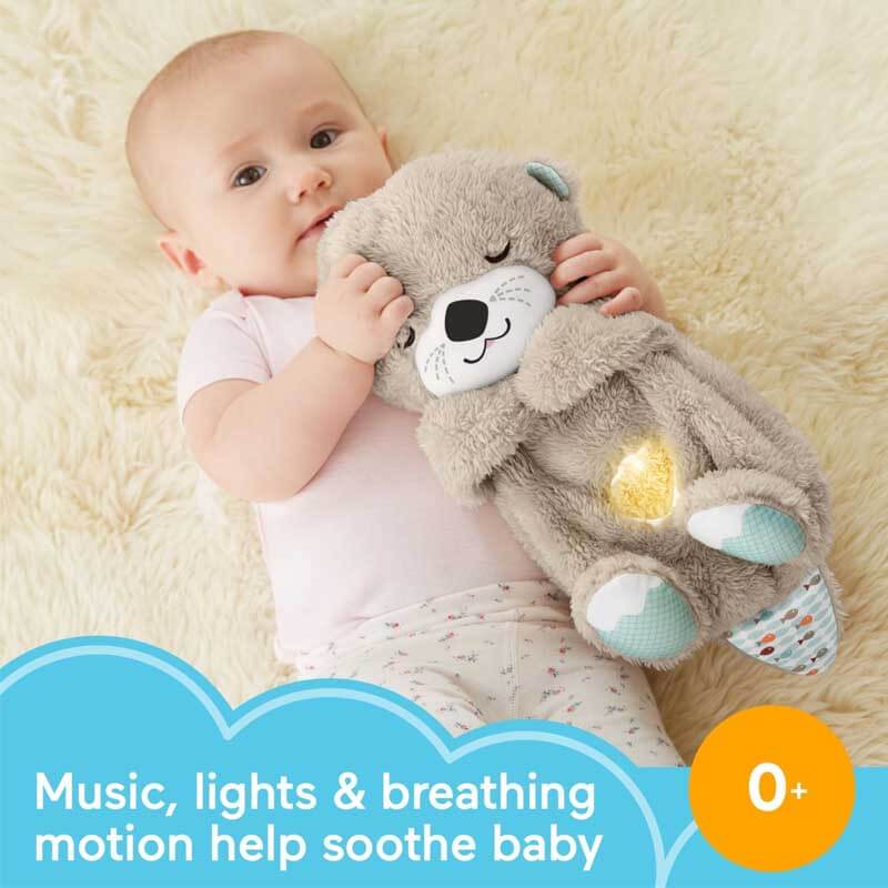 Infant gently touching a rhythmic breathing otter plush, a calming sensory toy
