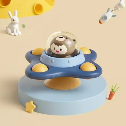 Infant reaching for a spinning suction cup toy on a smooth surface, enhancing motor development