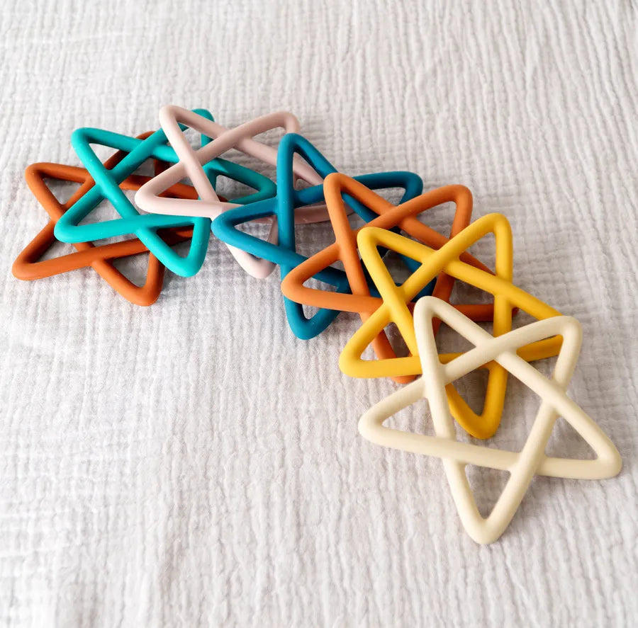 Textured star silicone baby teether, designed to reach back gums and provide relief