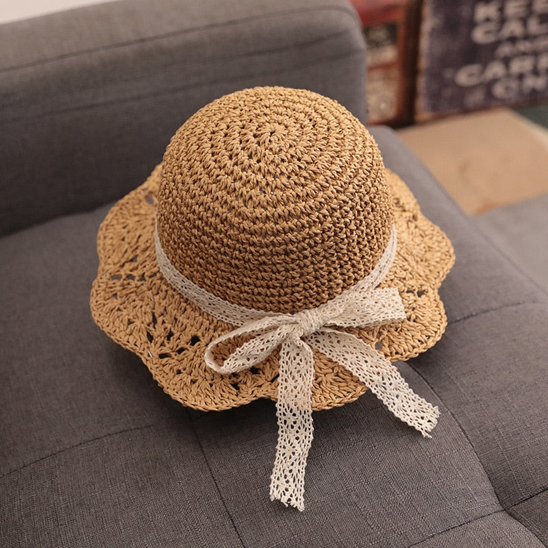 Toddler sun protection straw hat featuring a colorful band, essential kids fashion for summer.