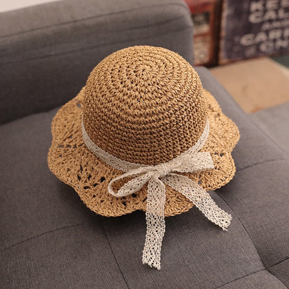Toddler sun protection straw hat featuring a colorful band, essential kids fashion for summer.