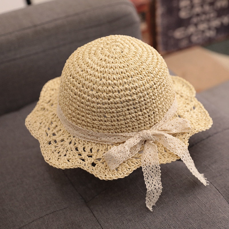 Stylish baby accessories: a light-colored straw hat for a toddler, great for sun protection.