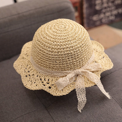 Stylish baby accessories: a light-colored straw hat for a toddler, great for sun protection.