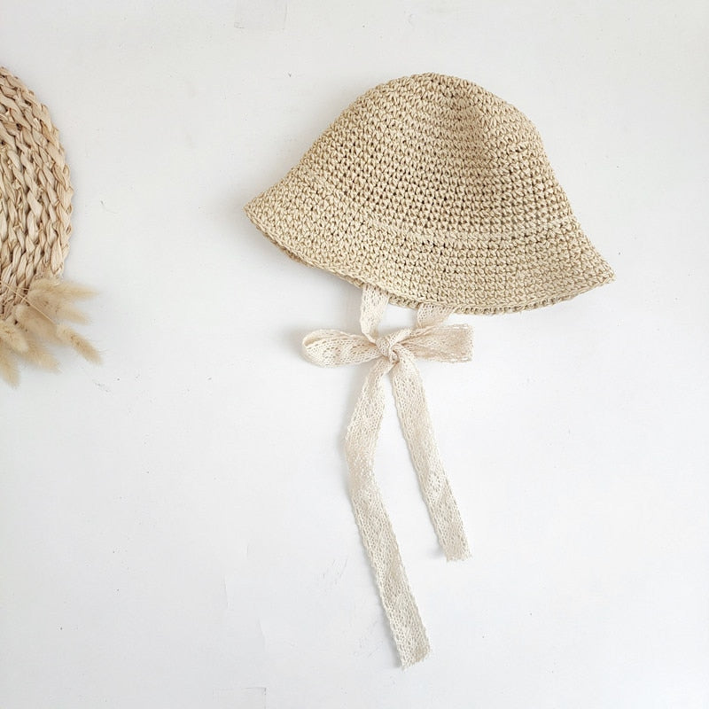Kids fashion straw sun hat for baby, with an adjustable chin strap for secure wear.