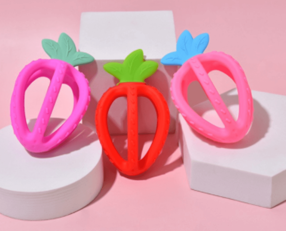 Stylish strawberry silicone baby teether with loop, a safe and effective chew toy for infants