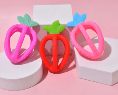Stylish strawberry silicone baby teether with loop, a safe and effective chew toy for infants