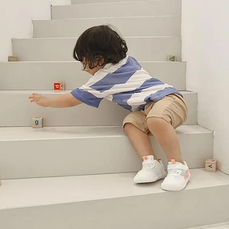 Side view of a grey baby toddler mesh breathable non-slip first walker shoe