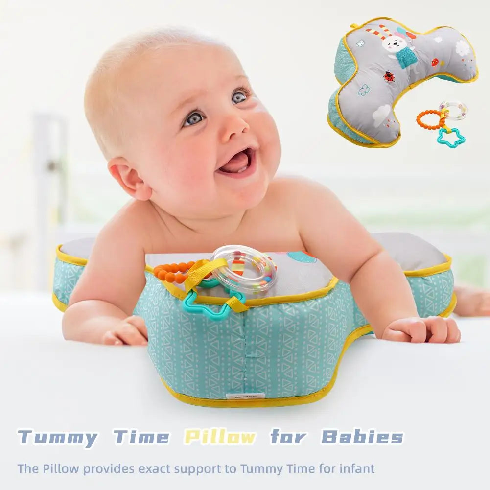 Soft baby tummy time activity pillow with high-contrast patterns and dangling sensory toys for infants.