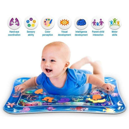 Happy baby enjoying tummy time on a water play mat, engaging with colorful fish & marine creatures.