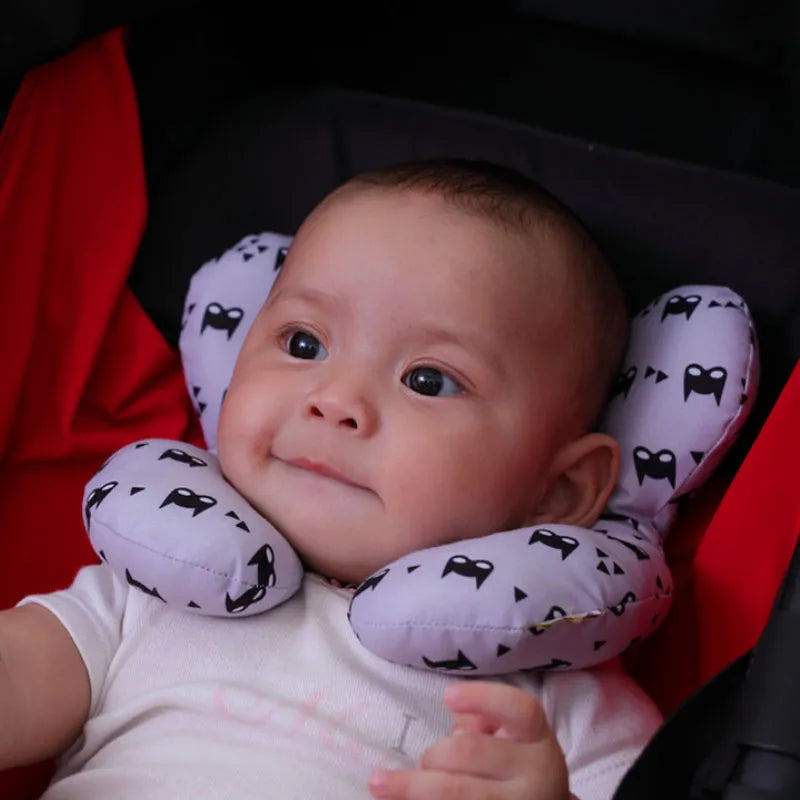 Side view of U-shape infant head support, showing ample padding for baby's neck protection in car