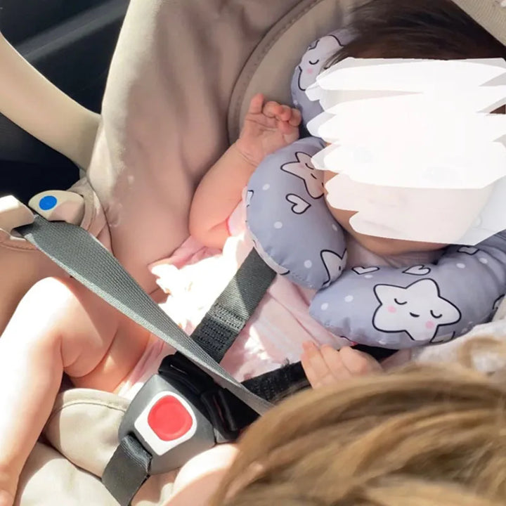 Close-up of a baby's head nestled in a U-shape travel pillow, ensuring snug and secure neck protection