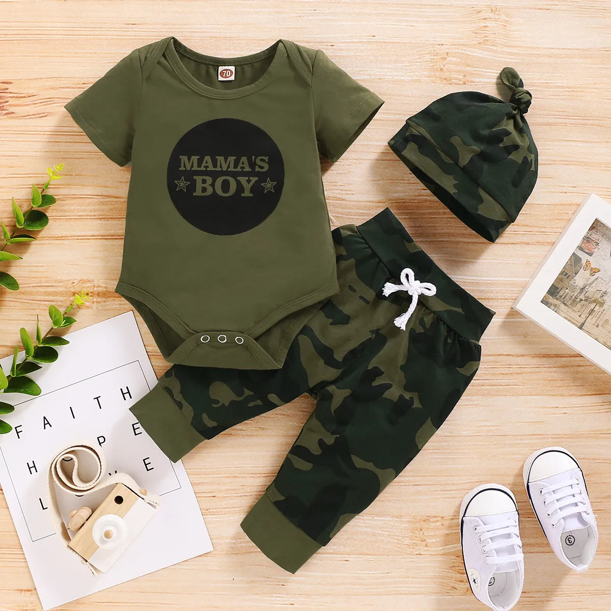 Newborn baby clothes set featuring a stylish camo print bodysuit and matching pants.
