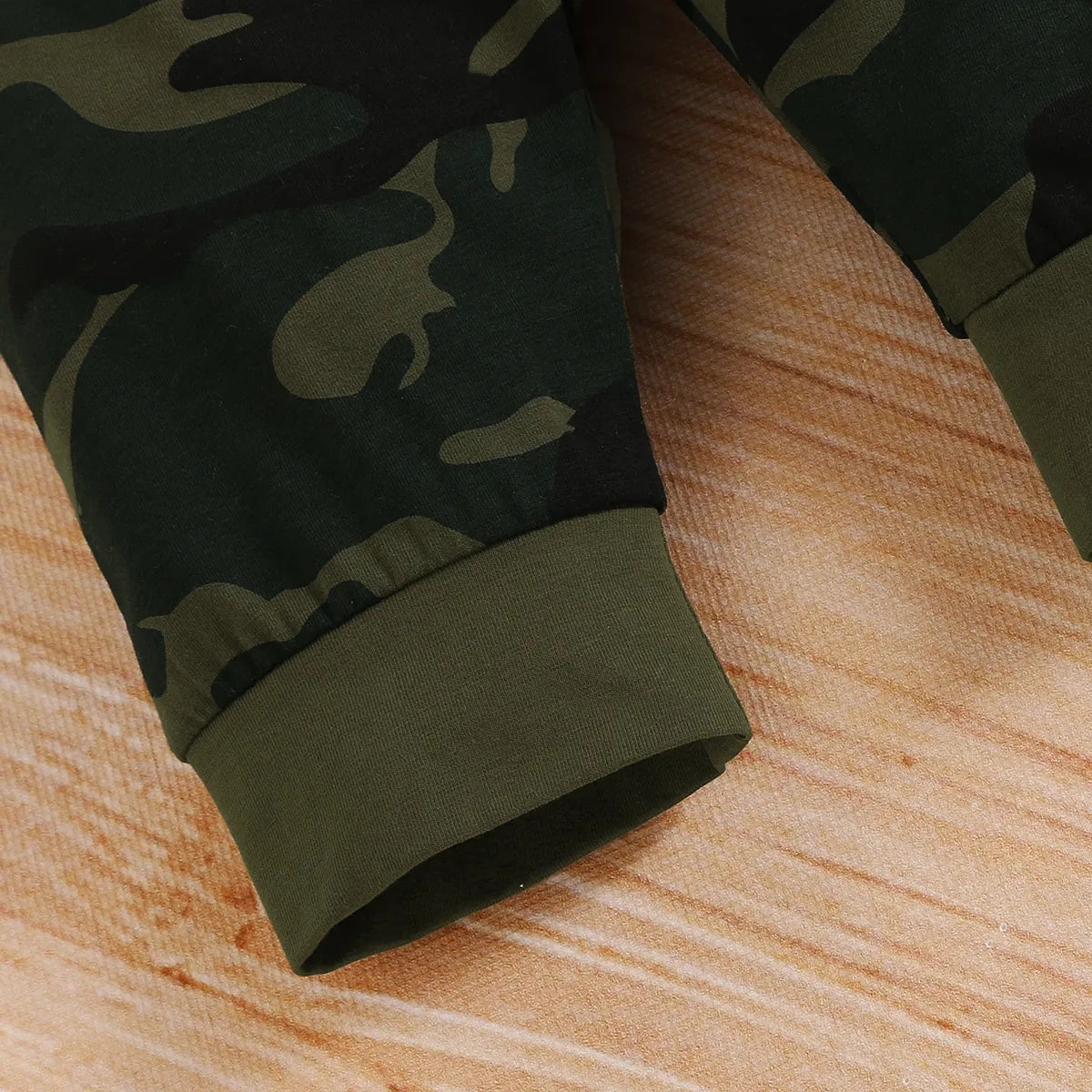 Comfortable baby clothes set: unisex camo print bodysuit and solid colored baby pants.