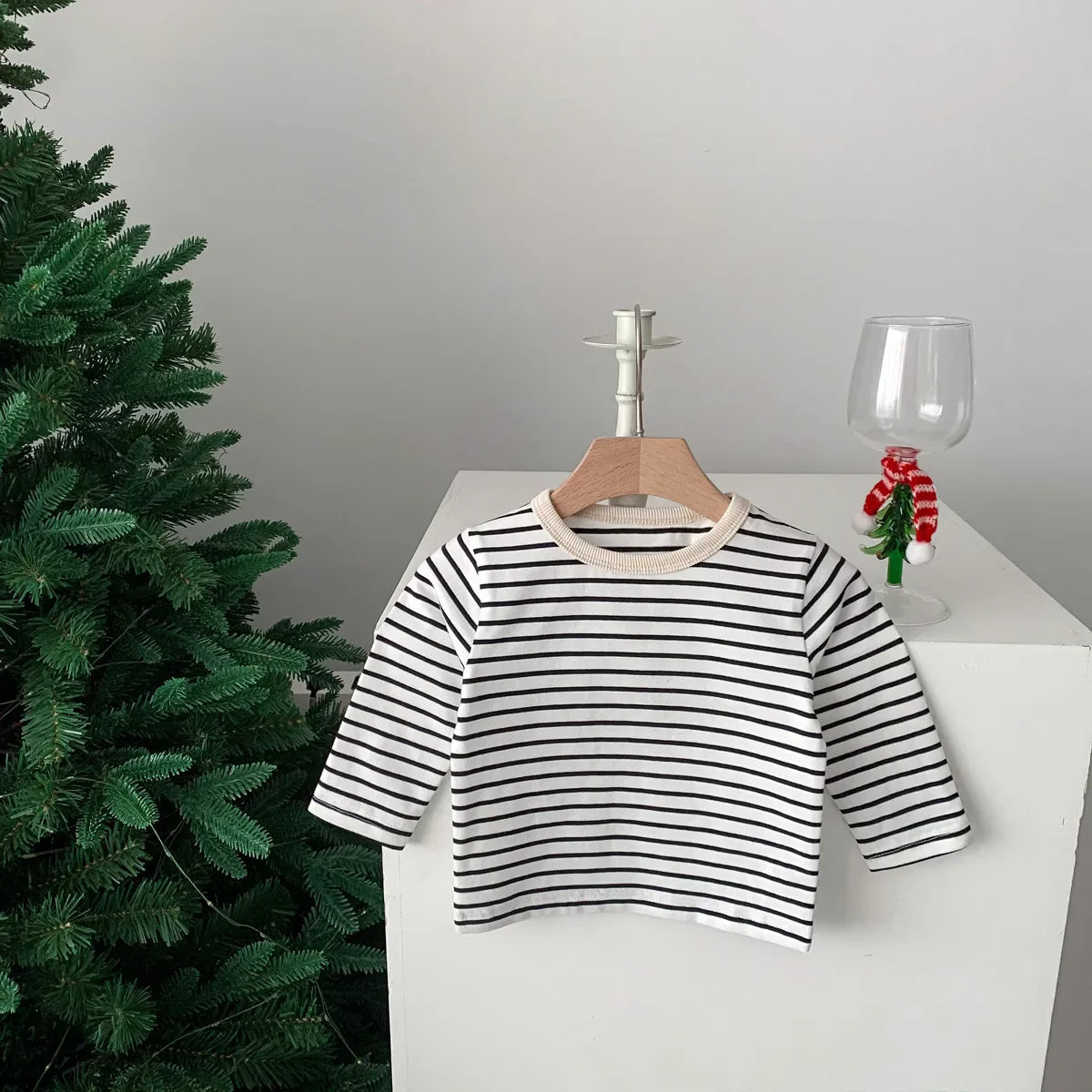 Stack of folded cotton short sleeve T-shirts: striped and plain, for kids fashion.