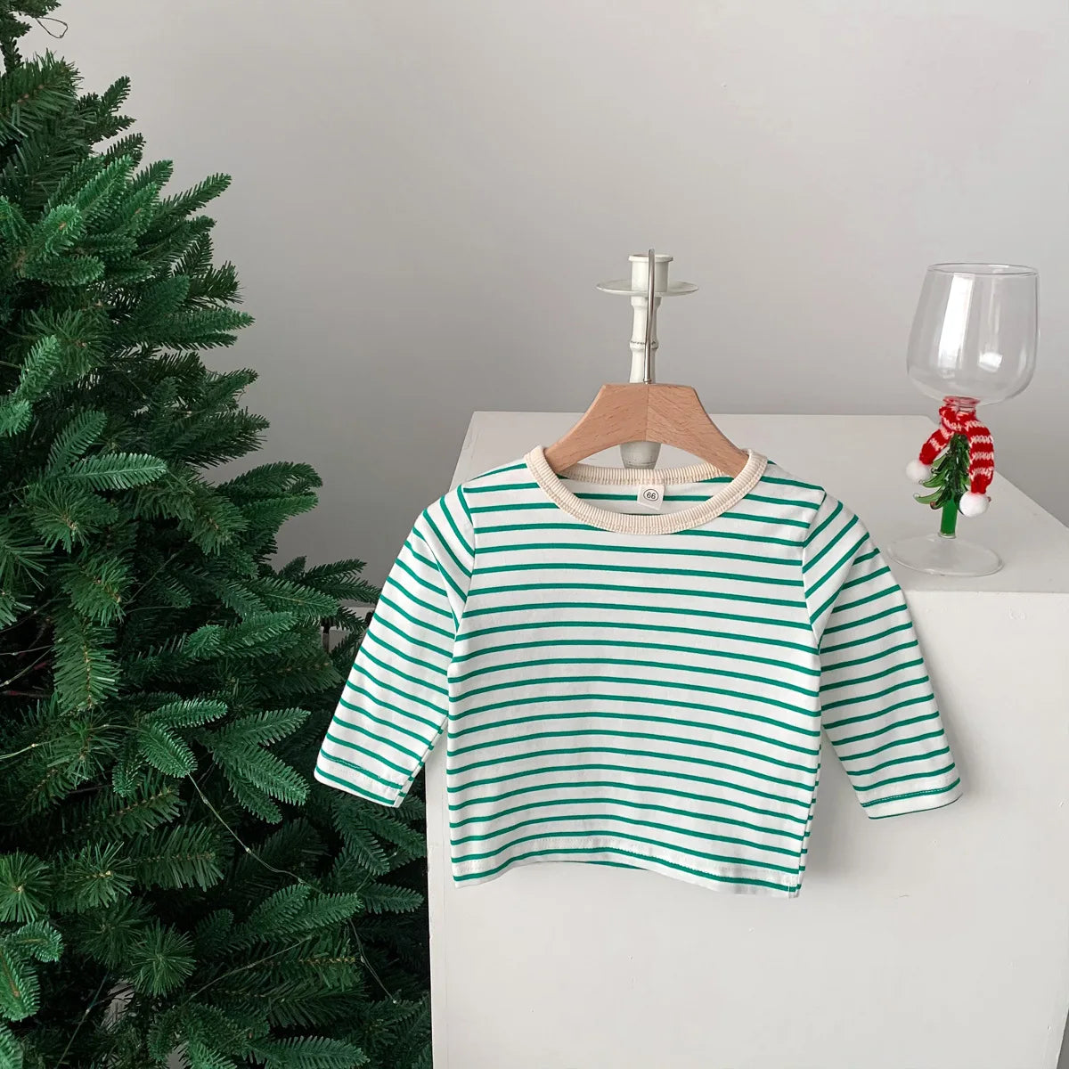 Close up of red and navy blue striped cotton short sleeve T-shirt for toddlers.
