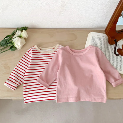 Assortment of plain and striped cotton short sleeve T-shirts for baby boys and girls.