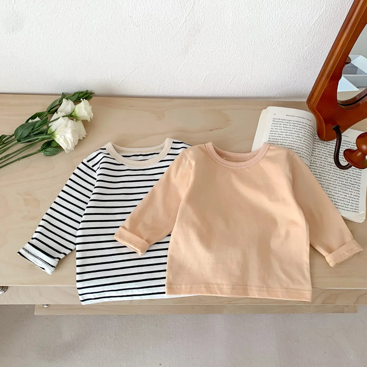 Newborn essentials: plain light pink cotton short sleeve T-shirt, soft unisex apparel.