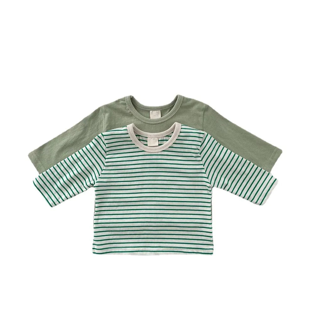 Close-up of soft cotton fabric on a plain white short sleeve baby T-shirt, unisex.