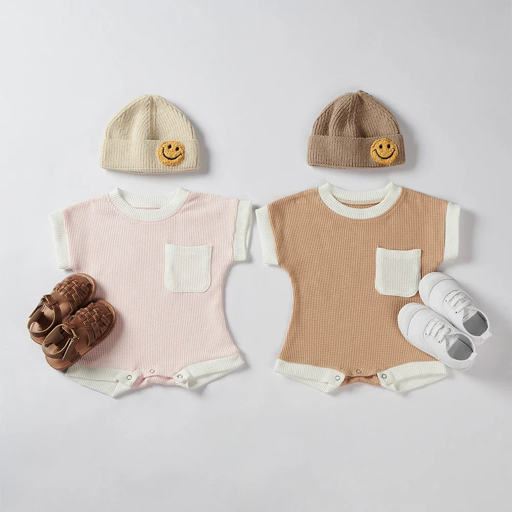 Close-up of the round neckline on a baby short sleeve cotton romper