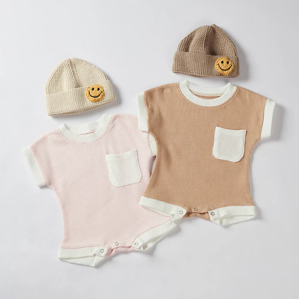 Full shot of a baby cotton waffle knit romper with short sleeves, front view