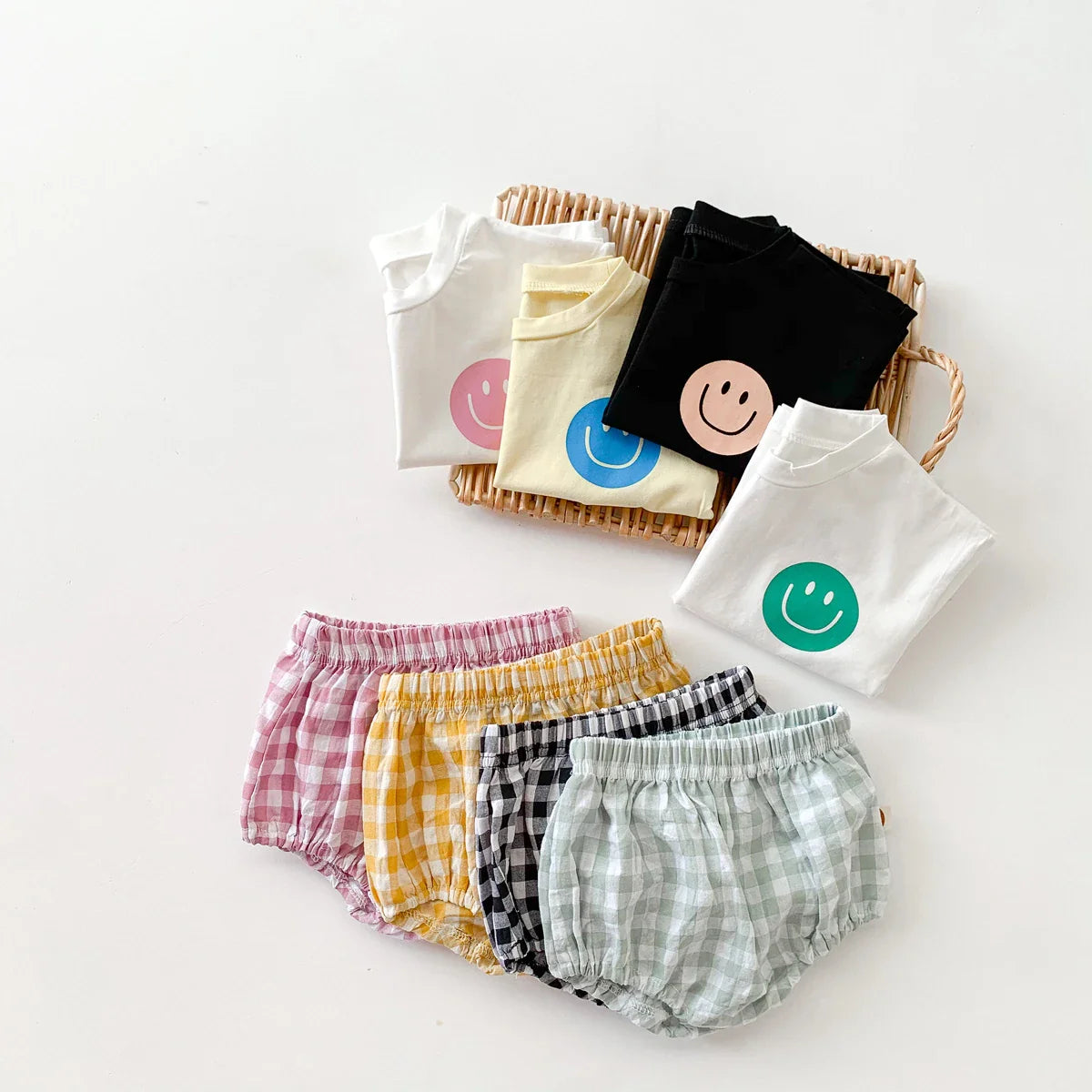 Children's summer fashion: cute smile face t-shirt and smart plaid shorts ensemble