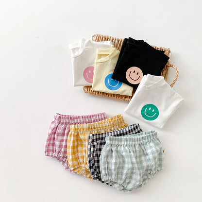 Children's summer fashion: cute smile face t-shirt and smart plaid shorts ensemble